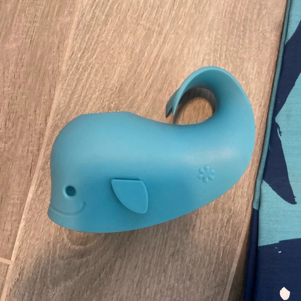 Pillowfort brand shark shower curtain and matching whale faucet cover.